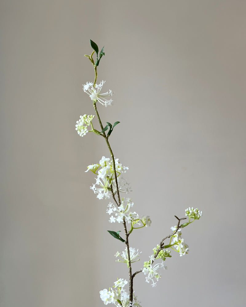 Kunstig, høj, hvid snow willow gren i en sandfarvet vase